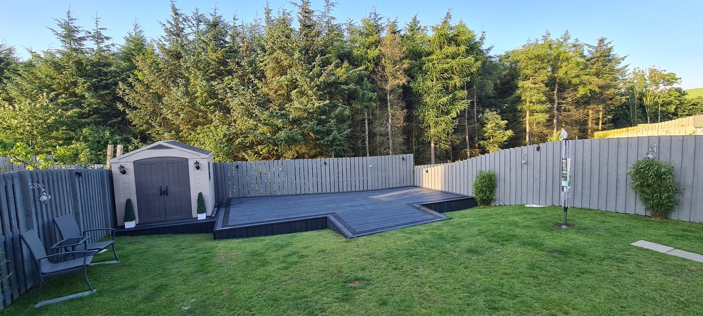 Composite decking with shed and lawn