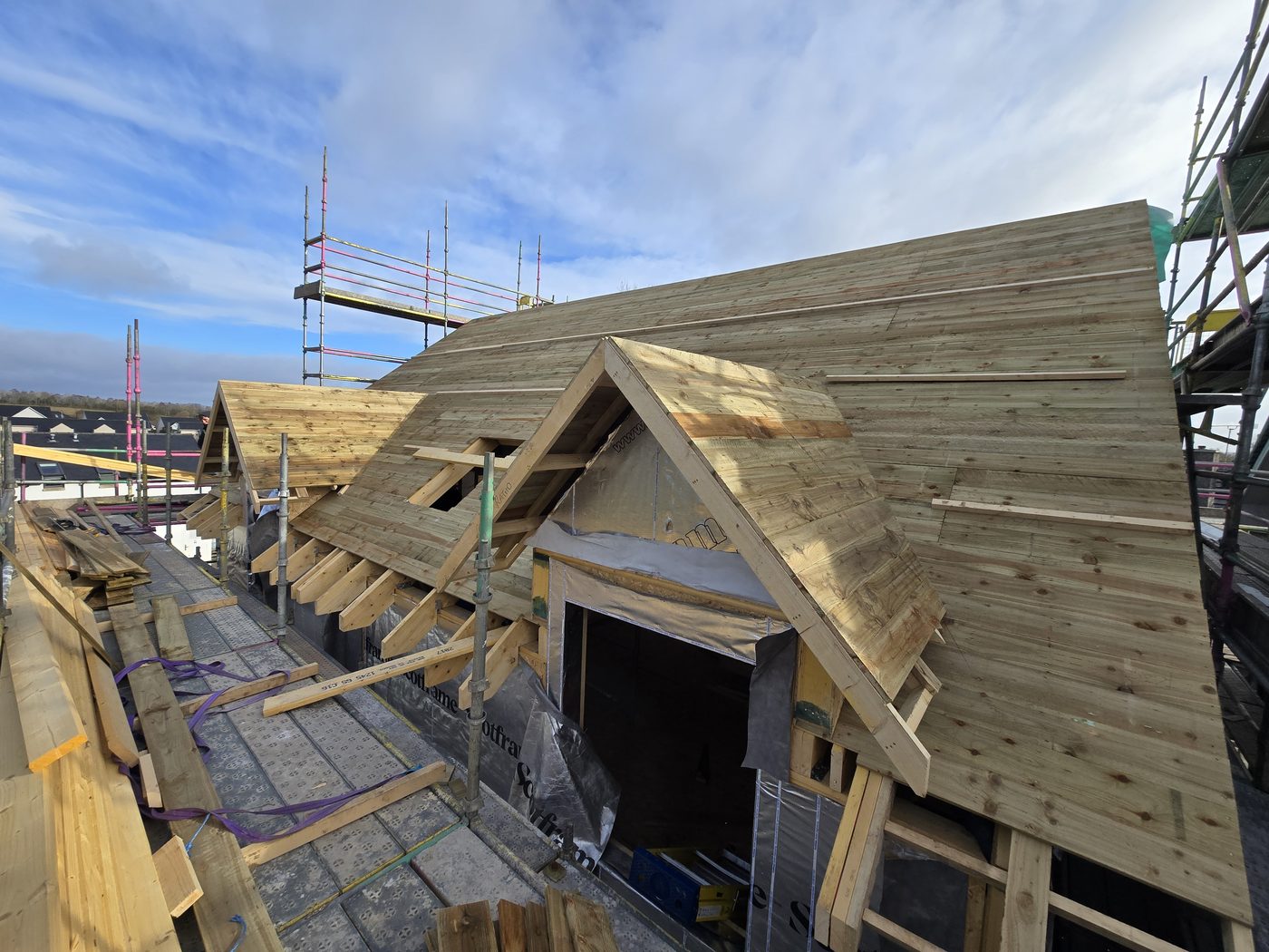 Timber kit roof being erected and made weathertight